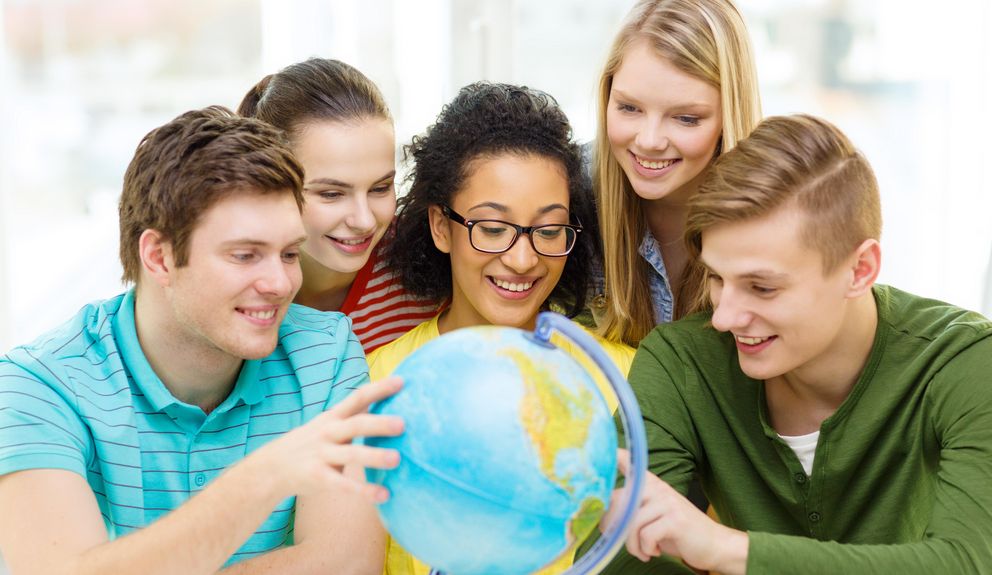 Students in front of a globe